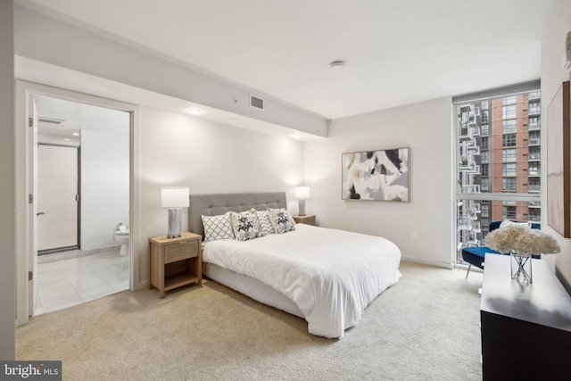 bedroom featuring carpet flooring and connected bathroom