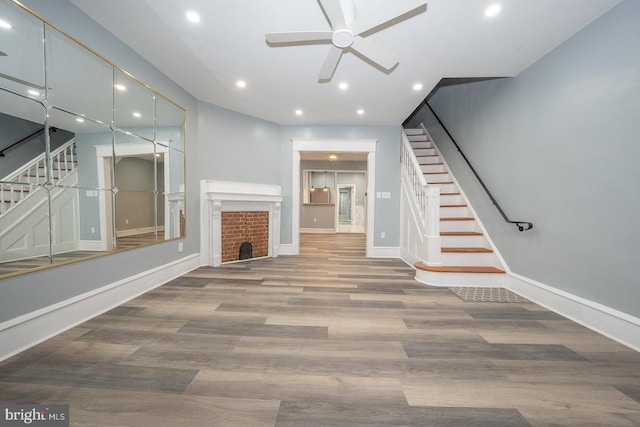 unfurnished living room with ceiling fan and hardwood / wood-style flooring