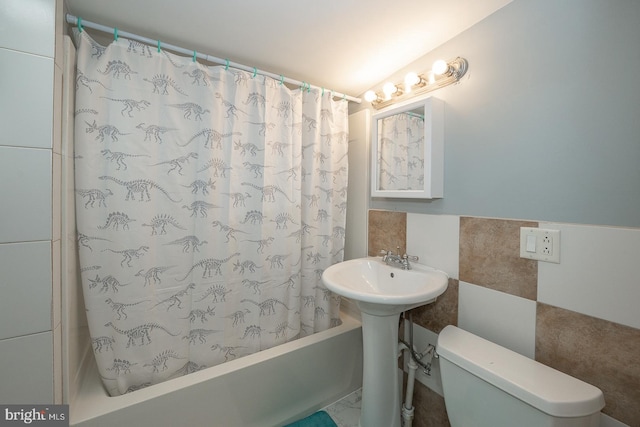 bathroom featuring toilet, tile walls, and shower / tub combo