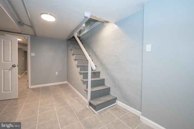 basement featuring light tile patterned floors