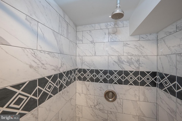 bathroom with a tile shower