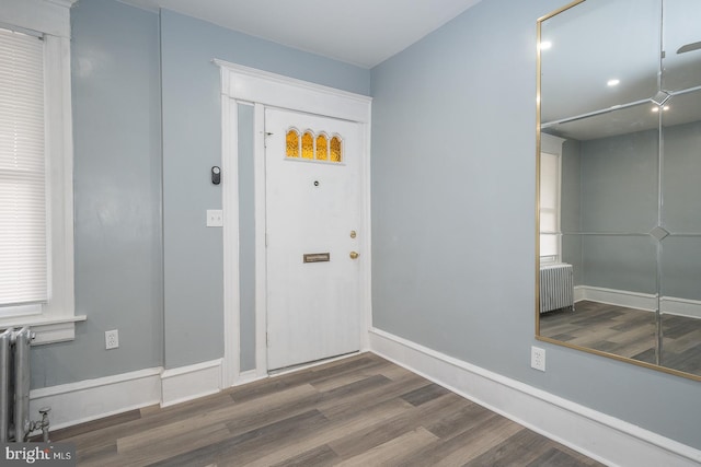 foyer entrance with wood-type flooring and radiator