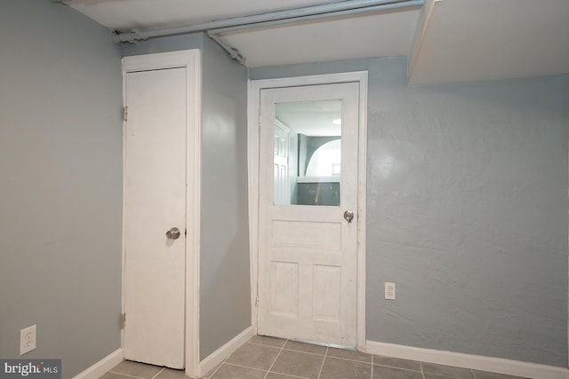 doorway with light tile patterned floors