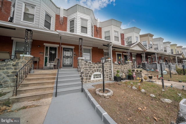 townhome / multi-family property featuring a porch