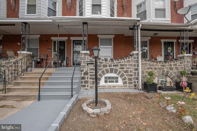 view of exterior entry with covered porch