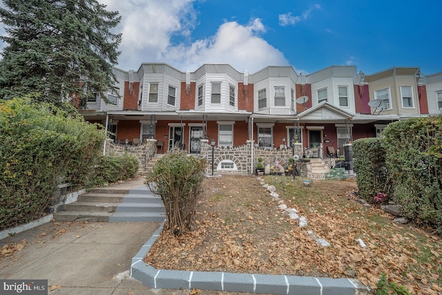 townhome / multi-family property with covered porch