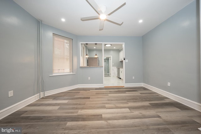 unfurnished room with hardwood / wood-style floors and ceiling fan