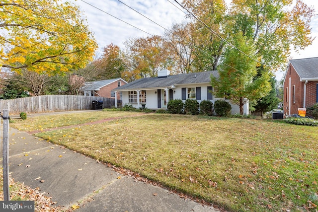 ranch-style house with a front yard and central AC