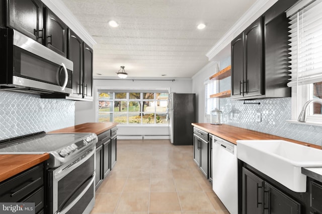 kitchen with stainless steel appliances, tasteful backsplash, a healthy amount of sunlight, and sink