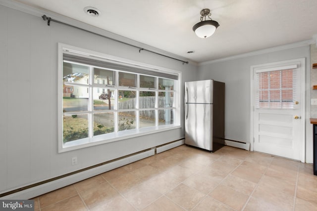 unfurnished dining area with ornamental molding, a baseboard radiator, and light tile patterned flooring