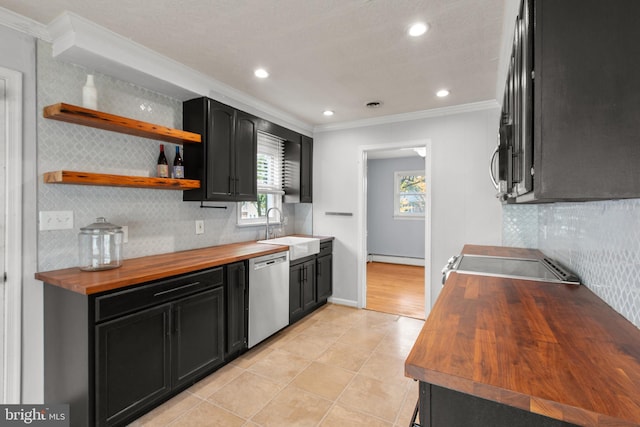 kitchen featuring wood counters, sink, appliances with stainless steel finishes, and ornamental molding