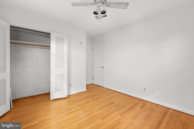 unfurnished bedroom featuring light hardwood / wood-style floors, ceiling fan, and a closet