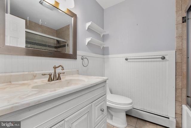 bathroom featuring tile patterned flooring, vanity, an enclosed shower, a baseboard radiator, and toilet