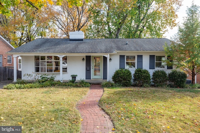 single story home with a porch and a front yard