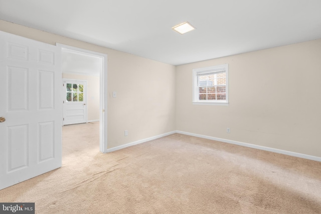 spare room featuring light colored carpet