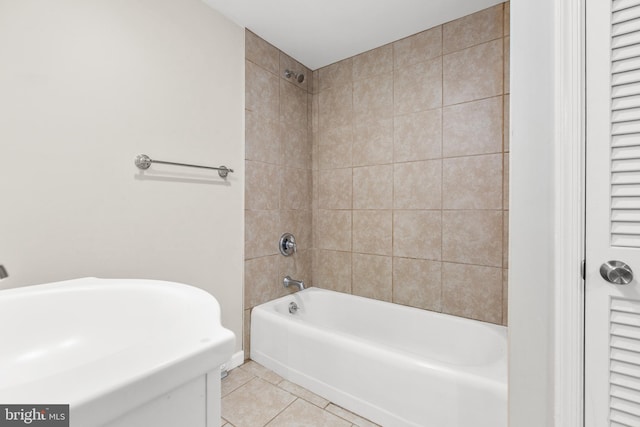 bathroom featuring tiled shower / bath combo and tile patterned flooring