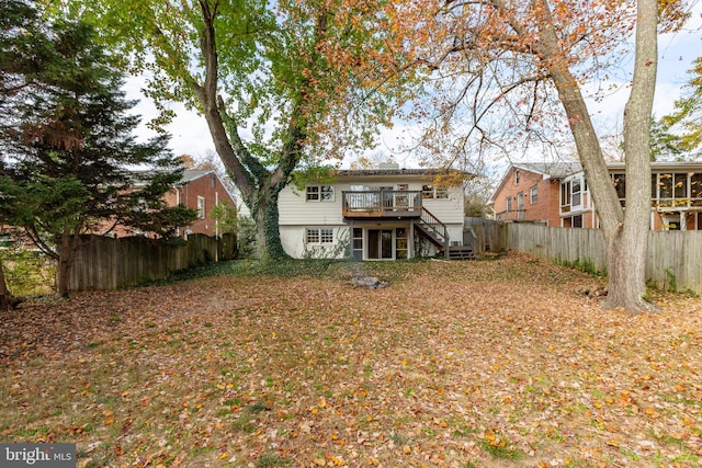 back of house with a deck