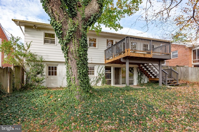 back of house with a yard and a deck