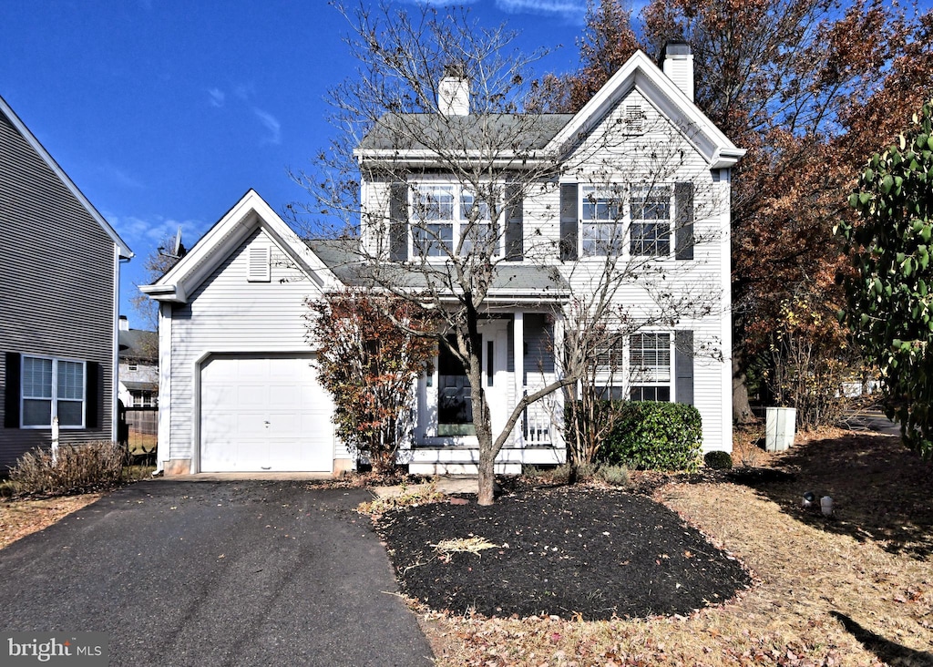 front facade featuring a garage and covered porch