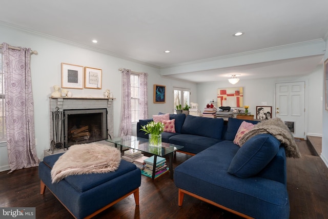 living room with a brick fireplace, crown molding, and hardwood / wood-style floors