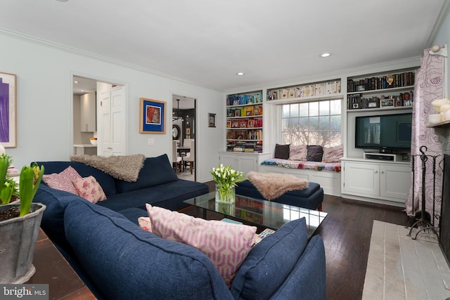 living area featuring ornamental molding, recessed lighting, dark wood finished floors, and built in features