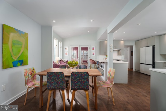 dining room with french doors, lofted ceiling, recessed lighting, dark wood-type flooring, and baseboards