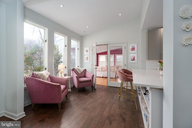 sitting room with vaulted ceiling, recessed lighting, dark wood finished floors, and a healthy amount of sunlight