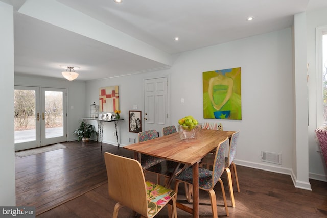 dining space featuring french doors, dark wood finished floors, visible vents, and baseboards