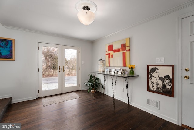 entryway with ornamental molding and wood finished floors