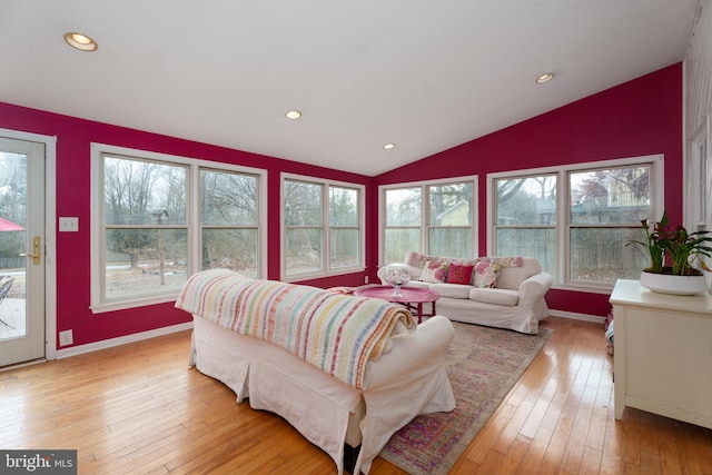 living room featuring light wood-style floors, lofted ceiling, a healthy amount of sunlight, and recessed lighting