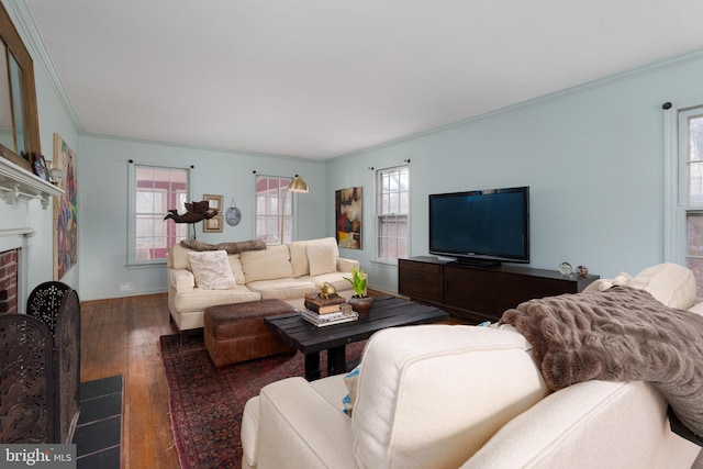 living room featuring a wealth of natural light, a brick fireplace, ornamental molding, and hardwood / wood-style floors