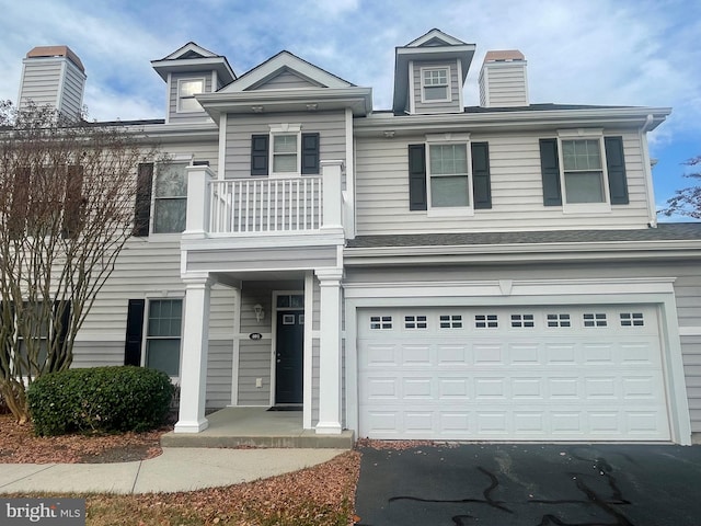 multi unit property with a balcony and a garage