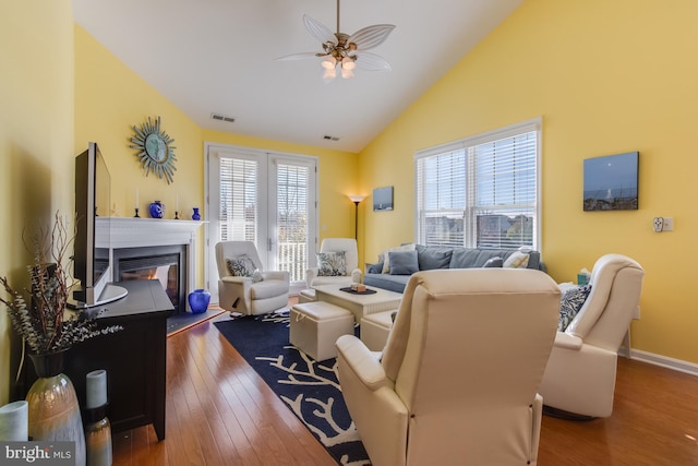 living room with ceiling fan, high vaulted ceiling, and dark hardwood / wood-style floors