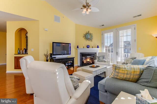 living room featuring vaulted ceiling, ceiling fan, and wood-type flooring