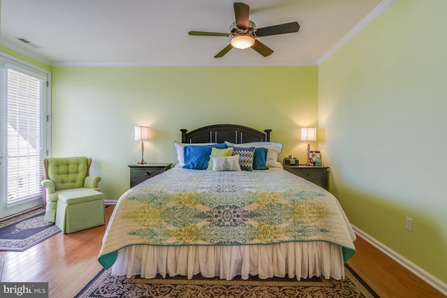 bedroom with hardwood / wood-style flooring, multiple windows, ornamental molding, and ceiling fan