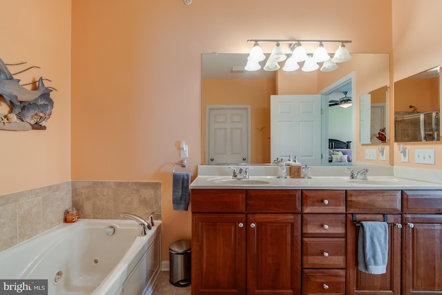 bathroom with tile patterned floors, a washtub, and vanity