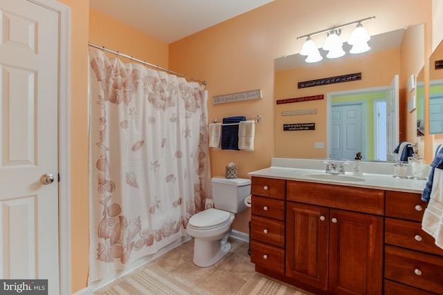 full bathroom featuring toilet, vanity, tile patterned floors, and shower / bath combo with shower curtain