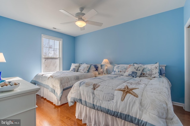 bedroom featuring light hardwood / wood-style floors and ceiling fan