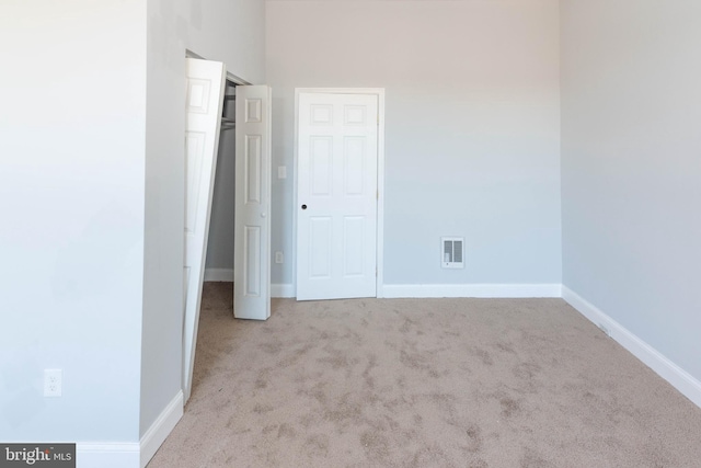 unfurnished bedroom featuring light colored carpet