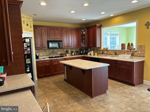 208 Glenshane Pass, Bear, DE 19701 - kitchen with black appliances, backsplash, a breakfast bar, glass insert cabinets, and a kitchen island