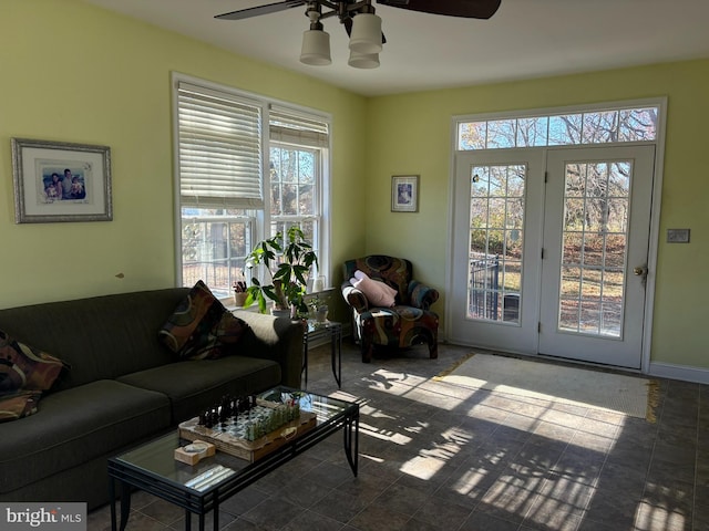 living room with ceiling fan and plenty of natural light