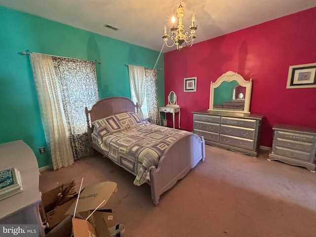 carpeted bedroom featuring a notable chandelier