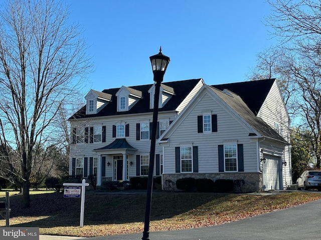 208 Glenshane Pass, Bear, DE 19701 - view of front facade with stone siding, a garage, and a front yard