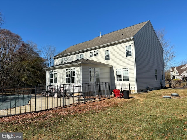 rear view of house featuring a yard