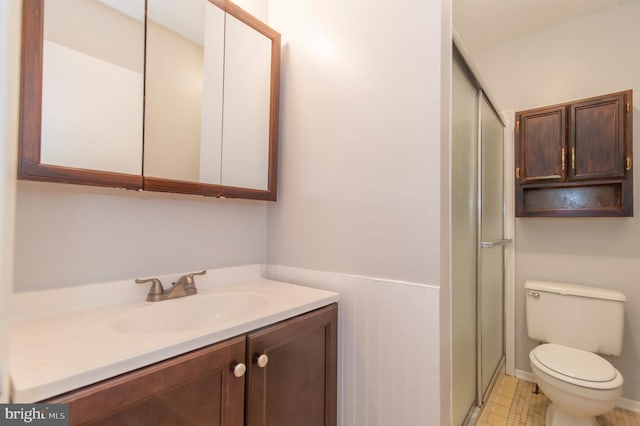 bathroom with vanity, toilet, and an enclosed shower