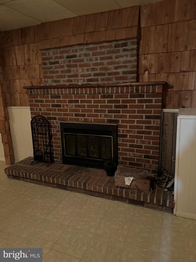 room details featuring a fireplace and wooden walls