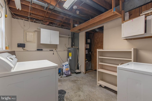 clothes washing area with washer and clothes dryer and water heater