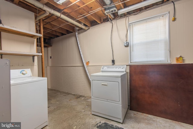 clothes washing area featuring separate washer and dryer