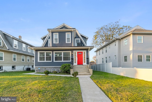 view of front of home featuring cooling unit and a front lawn