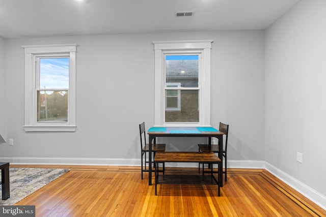 dining space with wood-type flooring